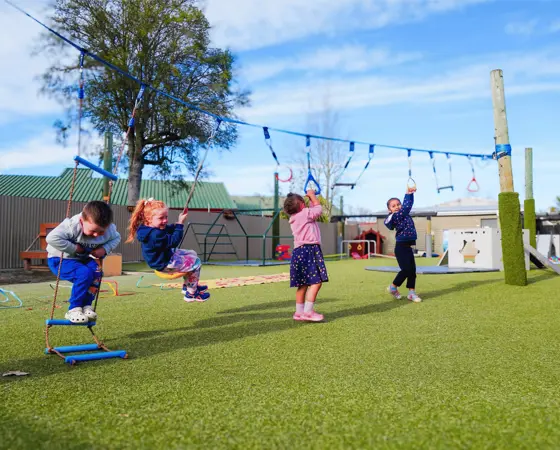 Children playing on a ninja slackline at Active Explorers Ashburton preschool