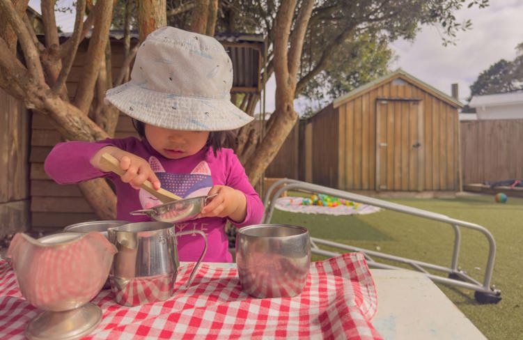 Evolve Education Preschool girl playing with tea set at daycare
