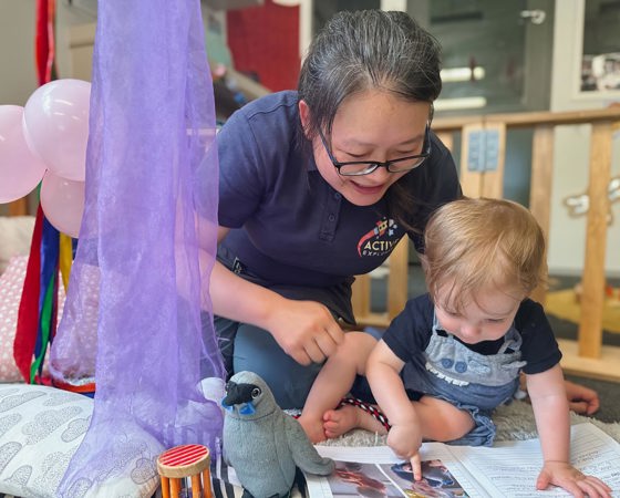 Evolve Education Teacher reading with baby